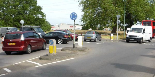 Mini roundabouts like this are just painted so that long vehicles have no problem negotiating them